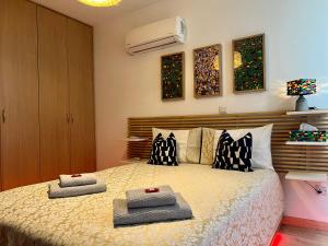 a bedroom with a bed with two pillows on it at Fat Cow Apartment 103 in Larnaka