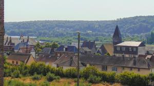 a view of a town with houses and a church at Les Pommerets in Le Petit-Couronne