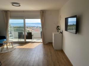 a living room with a floor to ceiling window with a view at Wellness Apartments Sunset in Zadar