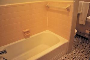 a white bath tub in a bathroom with a toilet at Lankford Hotel and Lodge in Ocean City
