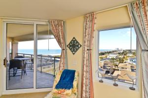 a room with a balcony with a view of the ocean at Tilghman Resort Ocean View Paradise Aw Lazy River & Indoor Outdoor Pools in Myrtle Beach