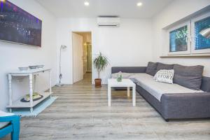 a living room with a couch and a table at Apartments Prgomet in Makarska