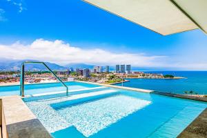 a swimming pool with a view of the ocean at Duva 903 in Puerto Vallarta