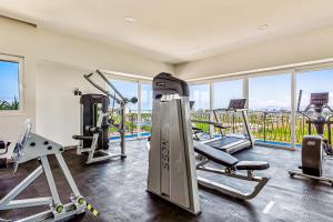 a gym with treadmills and machines in a building at Duva 903 in Puerto Vallarta