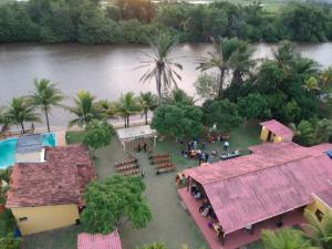an aerial view of a resort with trees and a river at Sítio em Guriri in São Mateus