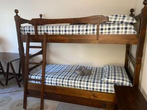 a bunk bed with a stuffed animal on the bottom bunk at Castagneto House in Baveno