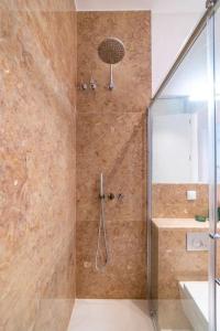 a bathroom with a shower with a glass door at Amaro III - Stunning penthouse apartment in Alcantara in Lisbon
