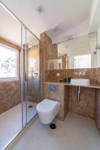 a bathroom with a toilet and a shower and a sink at Amaro III - Stunning penthouse apartment in Alcantara in Lisbon