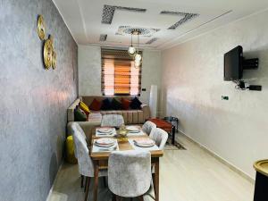 a living room with a table and a couch at Appartement INES Saidia in Saïdia