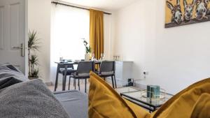 a living room with a table and chairs and a couch at Spacious home near Newcastle City Centre in Hebburn-on-Tyne