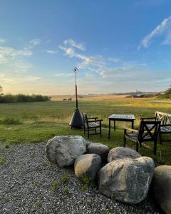 a park with two benches and a table and some rocks at Room 14 - Hawkraft kulturhotel in Vestervig