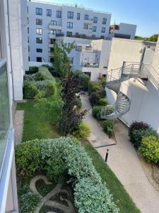 a view of a garden on the side of a building at Charming flat just outside Paris w free Private Parking in Saint-Ouen
