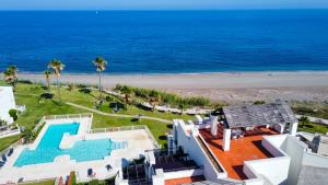 una vista aérea de una casa y de la playa en Exclusive luxury frontline beach penthouse Casares del mar - Estepona, en Casares