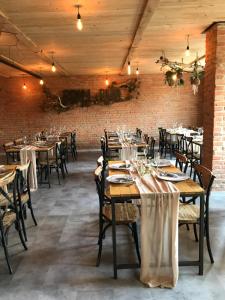 a dining room with tables and chairs and a brick wall at Rooms Svoboda in Olomouc +12 photos