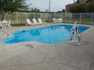 a small swimming pool with chairs around it at SureStay Plus Hotel by Best Western Auburn in Auburn