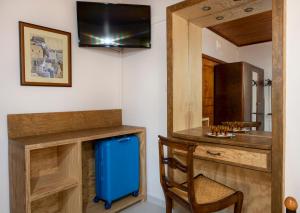 a room with a desk with a blue suitcase and a chair at Elisavet's House in Platanias