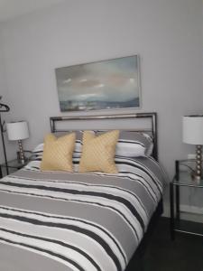 a bedroom with a large bed with yellow pillows at Caversham Lodge in Reading