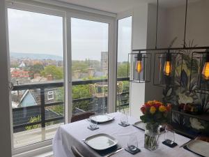 a dining room with a table with a view of a city at Clements House Swanage in Swanage