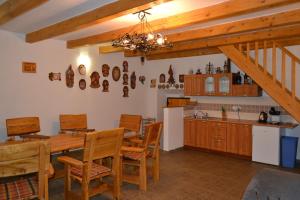 a kitchen with a wooden table and wooden chairs at Vinný sklep Pod zámkem in Jaroslavice