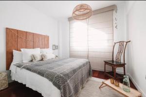 a bedroom with a large bed with a wooden headboard at La casita de vanessa in Playa del Hombre