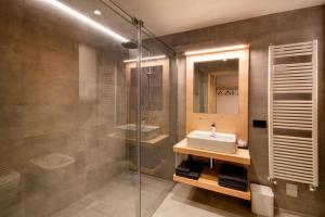 a bathroom with a sink and a shower at BORMIO N'JOY in Bormio