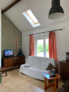 a living room with a bed and a window at Uroczy dom na Mazurach Jezioro Dybowskie in Dybowo
