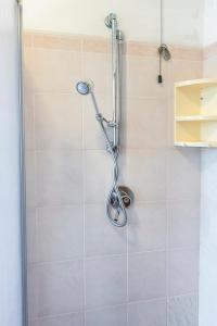 a shower with a shower head in a bathroom at SE006 - Senigallia, bilocale sul mare con spiaggia in Senigallia