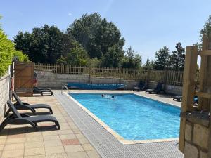 a pool with two people swimming in it at St Helens 2-Bed Lodge Sleeps 4 Pets Ok & Pool in Saint Helens