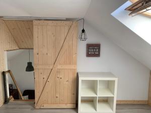a room with a wooden door and a table at Uroczy dom na Mazurach Jezioro Dybowskie in Dybowo