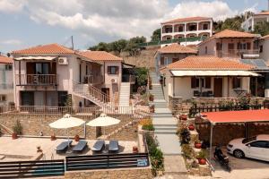 a group of houses with umbrellas in a town at Chroma in Finikounta