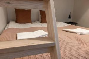 a bedroom with a bed with a wooden frame at 2ndhomes Kamppi Apartments 3 in Helsinki