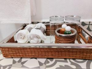 a basket with towels and other items on a shelf at Casa Allende Morelia in Morelia