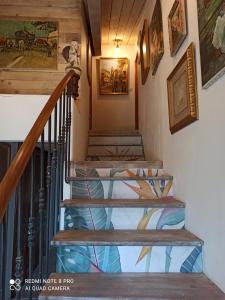 a staircase in a house with a painting on the wall at La Bohême in Charols
