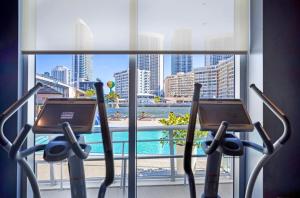 a hotel room with a view of a swimming pool at Beachwalk Resort #2301 - MODERN RESORT 3BDR and 3BA - BALCONY, GYM, AMAZING POOL in Hallandale Beach