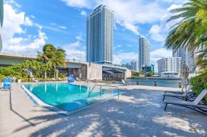 a swimming pool with a view of the city at Beachwalk Resort #2301 - MODERN RESORT 3BDR and 3BA - BALCONY, GYM, AMAZING POOL in Hallandale Beach