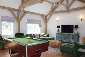 a living room with a pool table in it at The Anchorage Nables Farm in Chippenham