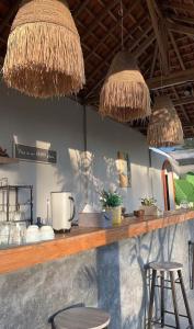 a bar with two stools and a counter with at Tantra Hotel in Krui