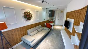 a living room with a couch and a television at Happy Apart Hotel in Kuşadası