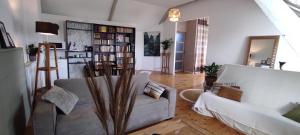 salon z kanapą i półką na książki w obiekcie La Lagosienne 