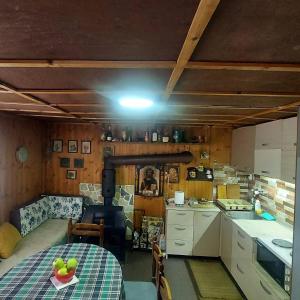 a kitchen with a table with a bowl of fruit on it at Villa Krompir in Tetovo