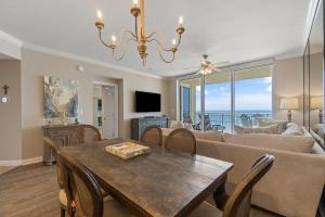 a living room with a table and a couch at Indigo East 1004 in Perdido Key