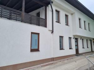 a white building with windows on the side of it at Lägenhet/Studio Grand in Jajce