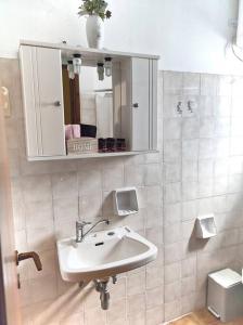 a bathroom with a sink and a mirror at Παραθαλάσσια μεζονέτα! in Kamena Vourla