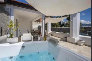 a large swimming pool in a house with a patio at Ravello Vingius Suite in Ravello
