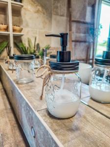 a glass jar filled with milk on a counter at Le Cotil Ribes in Grangues