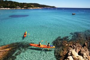 two people are in a kayak in the ocean at Mobil-home Parc Montana Gassin in Gassin