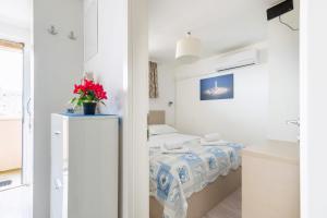 a small bedroom with a bed in a room at Frana Blue apartment in Split