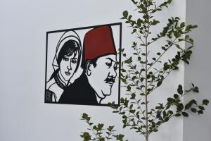 a picture of a man and a woman on a wall at Zoi Ayia Napa in Ayia Napa