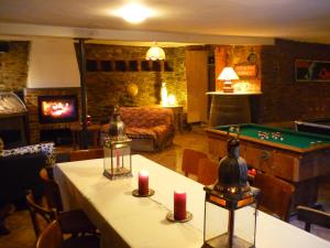 a living room with a table with two candles on it at B&B Les Trois Voisins in Bourseigne-Vieille