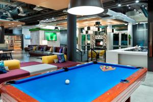 a billiard room with a pool table in it at Aloft Jacksonville Airport in Jacksonville